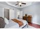 Spacious bedroom with tray ceilings, a closet with a barn door, and a dresser for storage at 655 Mead Se St # 79, Atlanta, GA 30312