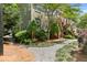 Charming townhome with beautiful landscaping, brick accents, and lush greenery around the exterior at 655 Mead Se St # 79, Atlanta, GA 30312
