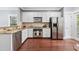 Well-equipped kitchen featuring stainless steel appliances, white cabinets, and granite countertops with access to the patio at 655 Mead Se St # 79, Atlanta, GA 30312