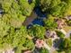 Aerial view of home nestled on a lot with mature trees and water views from a nearby pond at 988 Gentry Sw Ln, Marietta, GA 30064