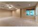 Finished basement with plush neutral carpet and a window letting in natural light at 988 Gentry Sw Ln, Marietta, GA 30064