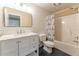 Bright bathroom features a marble countertop, white vanity, and shower with tub at 988 Gentry Sw Ln, Marietta, GA 30064