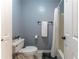 Cozy bathroom featuring a toilet, towel rack, shower with curtain, and grey walls at 988 Gentry Sw Ln, Marietta, GA 30064