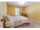 Bedroom featuring soft carpet, yellow walls, and a plush bed at 988 Gentry Sw Ln, Marietta, GA 30064