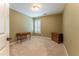 Bedroom with neutral carpet, shuttered window, and furnishings at 988 Gentry Sw Ln, Marietta, GA 30064