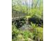 Scenic creek view with a metal bridge and lush green foliage, offering a serene natural setting at 988 Gentry Sw Ln, Marietta, GA 30064