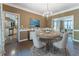 Formal dining room with chandelier lighting and views into the living room and kitchen at 988 Gentry Sw Ln, Marietta, GA 30064
