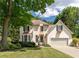 Charming two-story home with a well-manicured lawn, attached garage, and lush surrounding greenery at 988 Gentry Sw Ln, Marietta, GA 30064