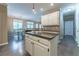 Open-concept kitchen features white cabinets, granite countertops, and a seamless connection to the dining area at 988 Gentry Sw Ln, Marietta, GA 30064