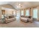 Bright living room featuring tan sofas, large windows, and access to the dining area at 988 Gentry Sw Ln, Marietta, GA 30064