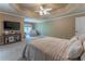 Comfortable primary bedroom features soft carpet, neutral colors, and tray ceiling at 988 Gentry Sw Ln, Marietta, GA 30064