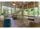 Relaxing screened porch with comfortable seating, tile flooring, and ceiling fan at 988 Gentry Sw Ln, Marietta, GA 30064