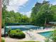 Community tennis courts and pool area, surrounded by lush trees and offering a great recreational space at 988 Gentry Sw Ln, Marietta, GA 30064