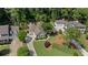 Aerial view showing the house, separate garage, driveways, and mature trees on the property at 11155 Highfield Chase Dr, Johns Creek, GA 30097