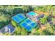 An aerial view of community amenities: tennis courts, swimming pool, clubhouse, and convenient parking at 11155 Highfield Chase Dr, Johns Creek, GA 30097