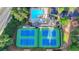 Aerial view showcasing community pool, tennis courts, and clubhouse, offering a comprehensive amenity package at 11155 Highfield Chase Dr, Johns Creek, GA 30097