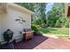 Back deck features a grill and overlooks a lush green lawn, creating an ideal space for outdoor cooking at 11155 Highfield Chase Dr, Johns Creek, GA 30097