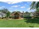 Large backyard with a screened-in porch, patio, and lush green lawn, perfect for outdoor gatherings and relaxation at 11155 Highfield Chase Dr, Johns Creek, GA 30097