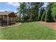 Expansive backyard featuring lush green grass and mature trees, perfect for outdoor activities and relaxation at 11155 Highfield Chase Dr, Johns Creek, GA 30097