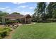Spacious backyard with patio, screened porch, and lush greenery, offering ample room for outdoor enjoyment at 11155 Highfield Chase Dr, Johns Creek, GA 30097