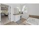 Well-lit bathroom features a tub, shower, and granite countertop vanity at 11155 Highfield Chase Dr, Johns Creek, GA 30097