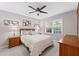 Bright bedroom featuring a comfortable bed, matching nightstands, and ample natural light from a window at 11155 Highfield Chase Dr, Johns Creek, GA 30097