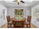 Breakfast nook with skylights and ceiling fan leads to screened-in back porch at 11155 Highfield Chase Dr, Johns Creek, GA 30097