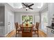 Breakfast nook with skylights and ceiling fan leads to screened-in back porch at 11155 Highfield Chase Dr, Johns Creek, GA 30097
