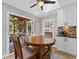 Breakfast nook features skylights and view of screened in back porch with seating at 11155 Highfield Chase Dr, Johns Creek, GA 30097
