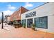 Exterior view of brick buildings featuring Comeback Vinyl and other businesses with outdoor seating and trees at 11155 Highfield Chase Dr, Johns Creek, GA 30097