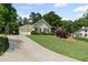 One-story home with neat landscaping and a long driveway leading up to the property at 11155 Highfield Chase Dr, Johns Creek, GA 30097