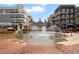 Community fountain in a commercial space with brick sidewalk, building facade, and street parking at 11155 Highfield Chase Dr, Johns Creek, GA 30097