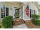 Inviting front entrance with brick steps and American flag at 11155 Highfield Chase Dr, Johns Creek, GA 30097