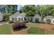 Charming single-story home featuring a well-manicured lawn, lush landscaping, and classic design at 11155 Highfield Chase Dr, Johns Creek, GA 30097