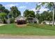 A single-story house with manicured lawn and trees at 11155 Highfield Chase Dr, Johns Creek, GA 30097