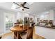 Kitchen and breakfast nook area with white cabinets and stainless refrigerator at 11155 Highfield Chase Dr, Johns Creek, GA 30097
