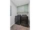 Modern laundry room with overhead storage cabinets and updated washer and dryer at 11155 Highfield Chase Dr, Johns Creek, GA 30097