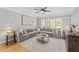 Comfortable living room with hardwood floors and a large sectional at 11155 Highfield Chase Dr, Johns Creek, GA 30097