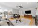 Open-concept living room with fireplace, kitchen, and breakfast nook area at 11155 Highfield Chase Dr, Johns Creek, GA 30097