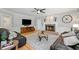 Spacious living room with fireplace, hardwood floors and leather sofas at 11155 Highfield Chase Dr, Johns Creek, GA 30097