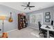 Comfortable home office with neutral walls, guitar decor, and a ceiling fan for added comfort at 11155 Highfield Chase Dr, Johns Creek, GA 30097