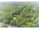 An aerial view of a beautiful home surrounded by lush greenery, showcasing its private and serene setting at 1609 Holly Ridge Dr, Loganville, GA 30052