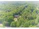 Aerial view showcases the stunning estate nestled amongst verdant trees, offering a sense of privacy and seclusion at 1609 Holly Ridge Dr, Loganville, GA 30052