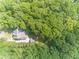 Aerial view of the home surrounded by lush greenery and towering trees, providing privacy and a serene setting at 1609 Holly Ridge Dr, Loganville, GA 30052