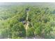 Home with long driveway leading to a secluded property surrounded by dense trees, ensuring peace and privacy at 1609 Holly Ridge Dr, Loganville, GA 30052