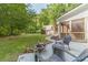 Enjoy a relaxing outdoor space with patio and fire pit in a lush wooded backyard with view of detached garage at 1609 Holly Ridge Dr, Loganville, GA 30052