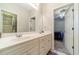 Bathroom with a double vanity, modern faucets, and doors leading to bedroom and another bathroom at 1609 Holly Ridge Dr, Loganville, GA 30052