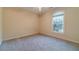 Neutral bedroom with carpet, base molding, and one window with a view of the outdoors at 1609 Holly Ridge Dr, Loganville, GA 30052