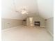 Large, carpeted bonus room featuring neutral walls and a ceiling fan at 1609 Holly Ridge Dr, Loganville, GA 30052