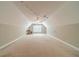 Spacious bonus room features neutral walls, carpet flooring, ceiling fan, and lots of natural light at 1609 Holly Ridge Dr, Loganville, GA 30052
